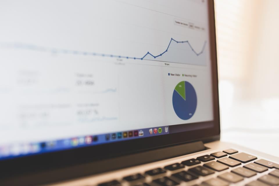 Analytics dashboard on a laptop showing website and enquiry data
